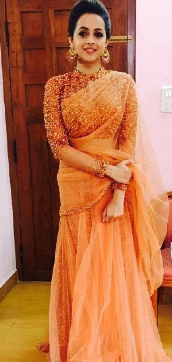 Pics: Malayalam film star Bhavana is engaged to Kannada producer Naveen, Mollywood congratulates Pretty Bhavana chose an orange-gold glittering saree and teamed it with Amrapali jewellery